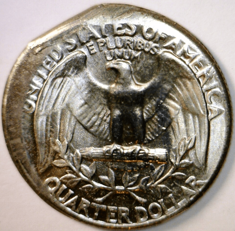 1967 Washington quarter off-center strike error showing partial design with blank planchet area and full date visible