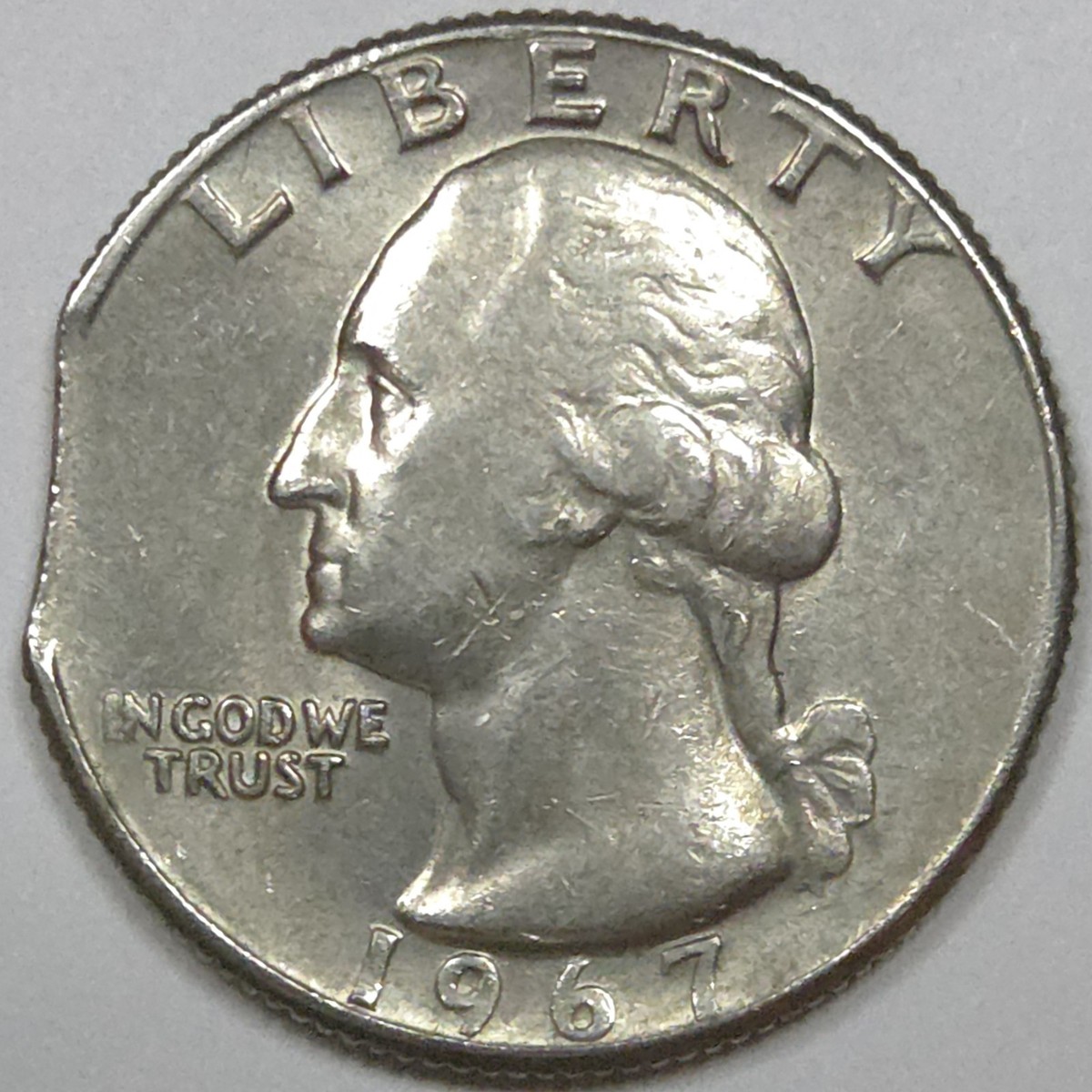 1967 Washington quarter clipped planchet error showing curved missing section along the coin edge